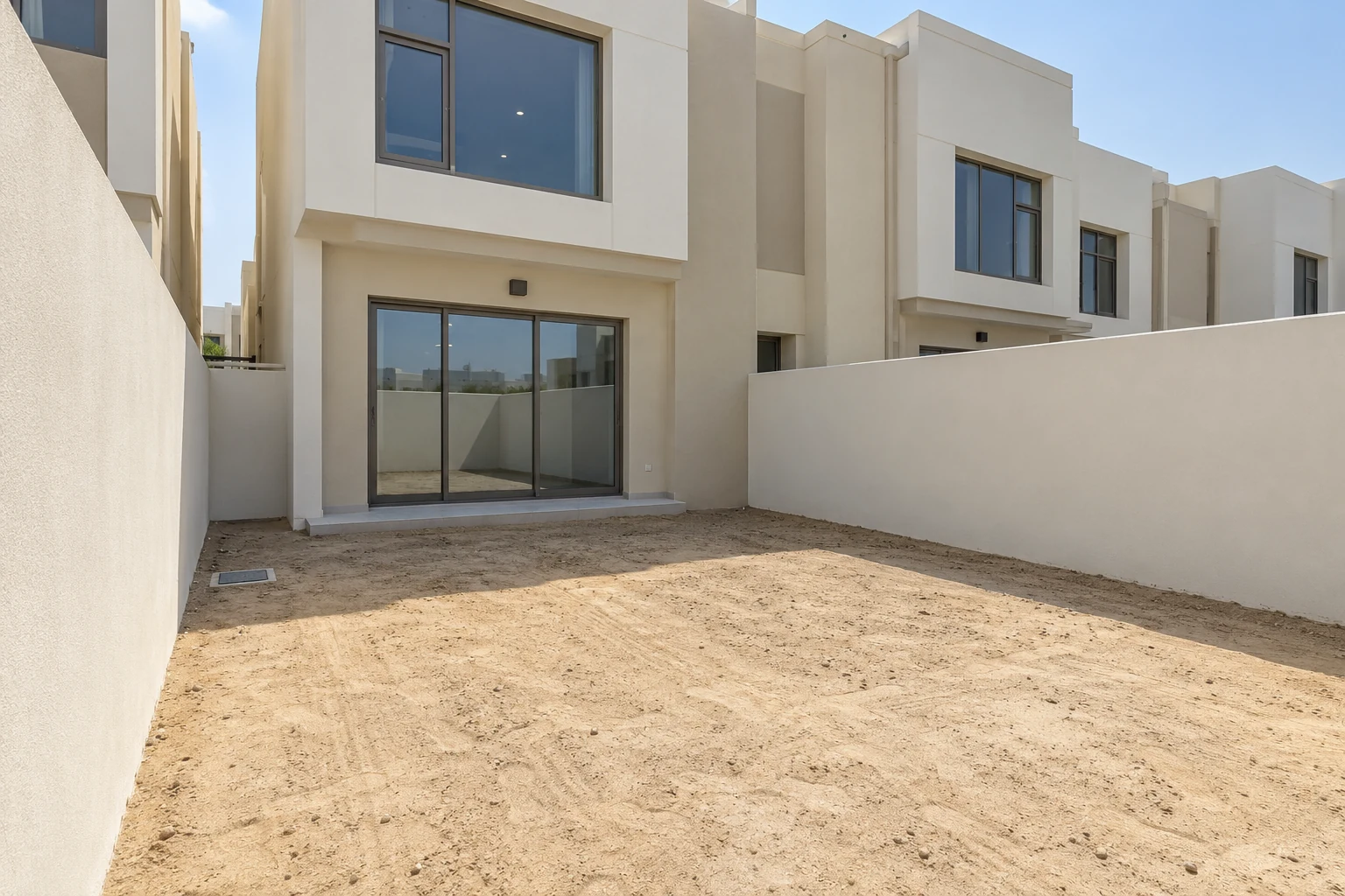 Design concept of a newly handed-over townhouse with a bare sandy garden